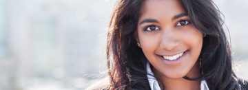 A woman with long hair and brown eyes.