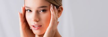 A woman with her hand on the side of her face.