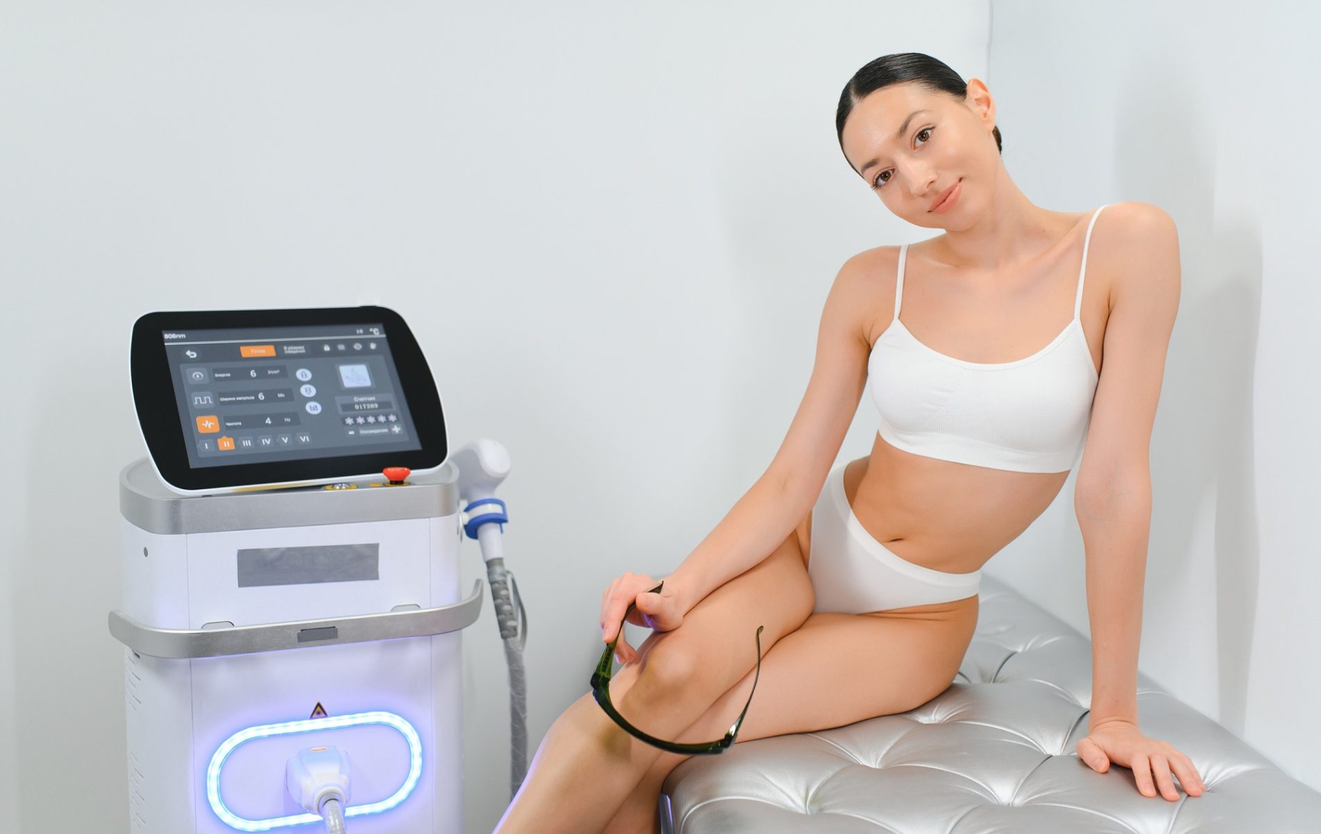 Young woman making body hair removal laser depilation in beauty center